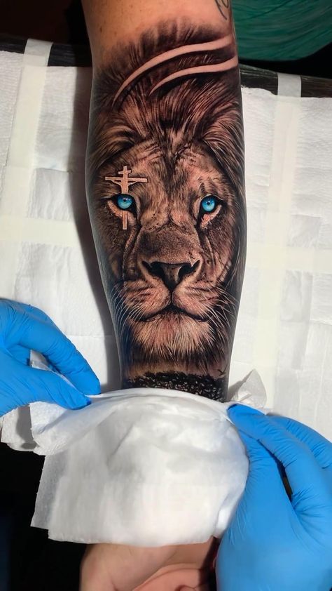 Tatoos Full Arm Men, Blue Eye Lion Tattoo, Mens Animal Tattoos, Lion Bible Tattoo, Forearm Lion Tattoo Men Ideas, Lion Blue Eyes Tattoo, Lions Tattoo Men, Lions Tatoos, Tattoo Lion Men