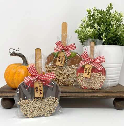 "These chunky wood candy apple shelf sitter would be adorable on your shelves, mantle or tiered tray this fall season. They are about .75\" thick and will stand on their own. The apples have been made with layers of various thicknesses of wood and had been accented with faux \"nuts\" and a cello bag with a wood tag.  The apples come in 3 sizes.  You can mix and match the sizes to the style. Large Apple (Chocolate in the picture) ~ 7.25\" tall x 4.5\" wide Medium Apple (Caramel in the picture) ~ 6.5\" tall x 4\" wide Small Apple (Candy Apple in the picture) ~ 5\" tall x 3\" wide Please note that colors may vary slightly due to the calibrations of various monitors, tablets or phones. This listing is for the Apple choice only and any other items shown in the listing photos are props and NOT I Dollar Tree Wood Apple Crafts, Candy Apples Caramel, Apple Chocolate, Fall Decorated Cookies, Faux Desserts, Apple Bar, Apple Crafts, Autumn Treats, Block People