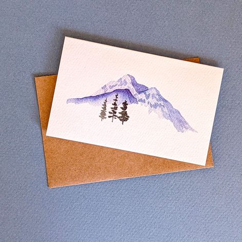 Gorgeous hand-painted watercolor mini-cards that are just oh-so-cute! Featuring a minimalist landscape with mountains and trees, the pack includes 6 mini cards and brown kraft-colored envelopes. These folded mini cards have a fun and beautiful minimalist design on the front, a blank interior, and a minimal backside. Their petite size makes them a favorite for kiddos and adults alike. Great for lunch box notes, gift card enclosures, or gift tags. Enough room for a small note, or just a simple to/ Winter Cards Handmade Simple, Watercolor Mini Landscapes, Mini Watercolor Paintings Simple, Simple Watercolor Christmas Cards, Watercolour Cards Simple, Watercolor Cards Ideas Simple, Simple Watercolor Cards, Winter Cards Handmade, Mini Greeting Cards