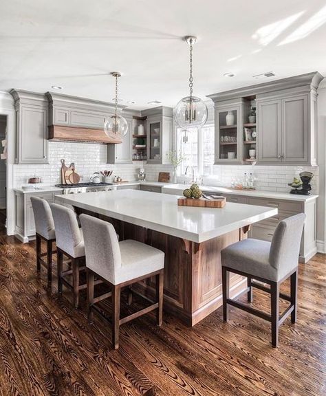 a modern farmhouse kitchen with a large kitchen island of wood and a white ston countertop that doubles as a dining table Remodel Pantry, Kitchen Chandeliers, Kitchen Design Countertops, 1960s Kitchen, Best Kitchen Countertops, 1970s Kitchen, Серая Кухня, Affordable Kitchen, Grey Kitchen Designs