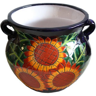 This pot has a cobalt blue background, but mostly decorated in the foreground with colorful sunflowers and some green leaves. A unique addition to your garden landscape! The dimensions shown are overall dimensions, the top opening is about 10" diameter. | Bungalow Rose Jayceion Glazed Pot Planter Ceramic in Black/Brown/Green, Size 13.0 H x 14.0 W x 14.0 D in | Wayfair Mexican Flower Pots, Talavera Planters, Mexican Colors, Small Sunflower, Planters For Sale, Ceramic Garden, Talavera Pottery, Plant Painting, Mexican Pottery