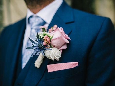 pink rose boutonniere with blue and ivory flowers on a navy suit Blush And Navy Boutonniere, Prom Corsage Blue, Wedding Photos Groomsmen, Pink Rose Boutonniere, Hoco Bouquet, Wedding Flowers Navy Blue, Gentlemen Club, Blue Corsage, Blue Boutonniere