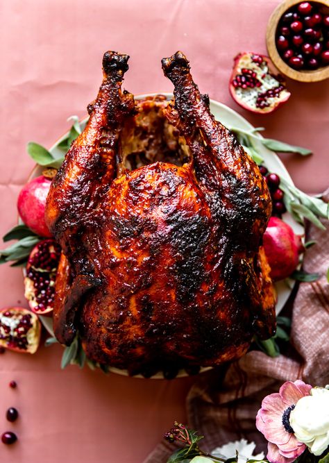 Cranberry Pomegranate Glazed Turkey | KJ & Company - a fun and delicious twist on a classic roasted turkey! Cranberry puree and pomegranate juice simmer together with brown sugar and fresh herbs to create a decadent glaze to baste your turkey with while it is roasting in your oven. The result is a juicy turkey that is not only loaded with flavor, but beautiful to look at! Get the recipe at https://kjandcompany.co #recipe #thanksgiving #turkey #cranberry #pomegranate #thanksgivingrecipe Turkey Roasting Times, Easy Turkey Recipes Thanksgiving, Oven Roasted Whole Chicken, Easy Thanksgiving Turkey, Roasting Times, Whole Chicken Recipes, Turkey Glaze, Whole Roasted Chicken, Cooking Courses