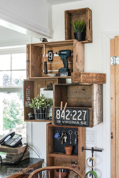 Stacked vintage crates and a reclaimed wood shelf for a rustic kitchen phone station against white walls. | funkyjunkinteriors.net Wood Crates Shelves, Vintage Crate Decor, Wooden Crates On Wall, Wood Crate Decor, Kitchen Chairs Diy, Crate Shelves Bathroom, Crates On Wall, Farmhouse Kitchen Chairs, Milk Crate Storage