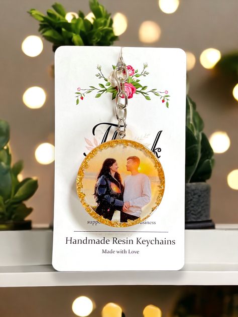 A beautiful couple photo resin keychain is a heartfelt keepsake that encapsulates the essence of love in a tangible form. The delicate resin encases a cherished photograph, capturing a moment frozen in time, radiating with the warmth and tenderness shared between two souls✨❤️ #Resinkeychain #Couplephotoresinkeychain #Giftideas #giftideasforher #amarcrafts Resin Art Photo Keychain, Resin Round Keychain, Resin Couple Gift Ideas, Resin Photo Keychain Ideas, Resin Photo Keychain, Photo Resin, Resin Idea, Couple Keychains, Diy Resin Phone Case