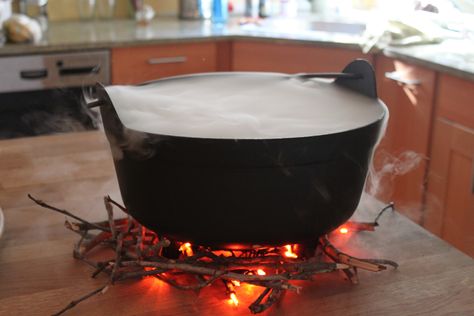 Smoking cauldron, for halloween party idea. I used a black cauldron, a string is orange Halloween lights and sticks from the yard for the fire. I used a large glass bowl and placed that inside the cauldron filled it with the punch. . The dry Ice was placed in chunks inside the cauldron not in the glass bowl. Then add small increments  of hot water on top of the dry ice, smoke will really start to flow. Dry Ice Halloween, Halloween Punch Bowl, Witch's Cauldron, Cheap Diy Halloween Decorations, Dekorasi Halloween, Black Cauldron, Halloween Punch, Large Glass Bowl, Bubble Bubble