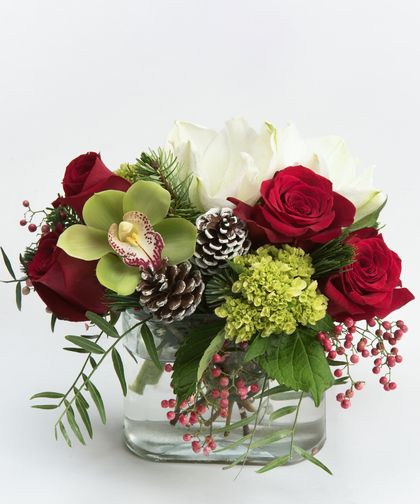 Snowflake - A collection of roses, amaryllis and orchids in shades of green, red, and white is gathered in our oval glass vase with simple seasonal accents. Christmas Rose Arrangement, Red White And Green Flower Arrangements, White Rose Christmas Centerpiece, Holiday Table Arrangements, Fresh Flower Christmas Centerpieces, Modern Christmas Floral Arrangements, Holiday Floral Centerpieces, Red And White Flower Arrangements, Christmas Flower Centerpieces