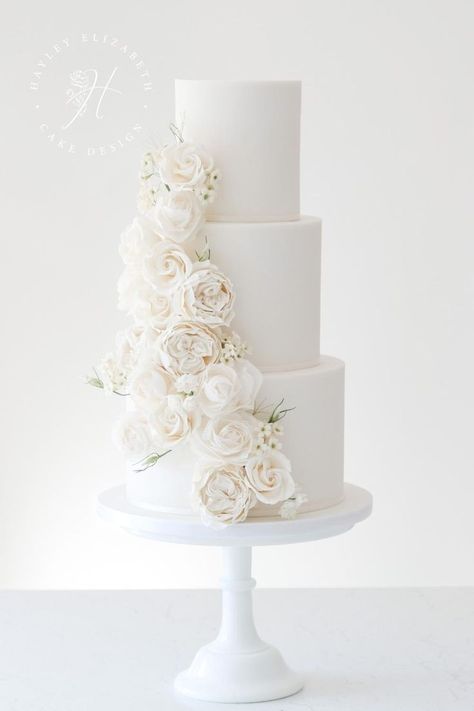 White wedding cake designs in Hampshire | elegant wedding cake by Hayley Elizabeth | wedding cakes elegant romantic | elegant white wedding cake | all white wedding cake classy | wedding cake with sugar flowers | all white wedding cake ideas | luxury wedding cake design | fine art wedding cake | white wedding | luxury white wedding #weddingcakes #whitewedding Buttercream White Wedding Cake, Romantic Wedding Cake 3 Tier, Simple Wedding Cake White Roses, Plane White Wedding Cake, Clean White Wedding Cake, Stunning Wedding Bouquets, All White Wedding Cake With Flowers, White Wedding Cake With Roses, Modern 4 Tier Wedding Cake