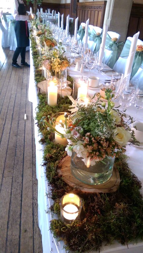 Top table decoration of moss, flowers and candles by Halo Blossom Floral Design Moss Wedding Table, Moss Centerpiece Wedding, Lavender Wedding Centerpieces, Top Table Decoration, Medieval Wedding Theme, Moss Table Runner, Lace Table Runner Wedding, Moss Flowers, Neutral Wedding Decor