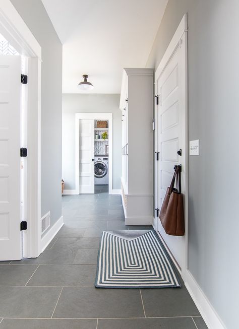 Blue and gray mudroom with slate tile for a classic feel in this lake house. Blue Mudroom, Mudroom Paint, Gray Tile, Gray Painted Walls, Lake House Interior, Mudroom Design, Casa Vintage, Slate Flooring, Grey Tiles