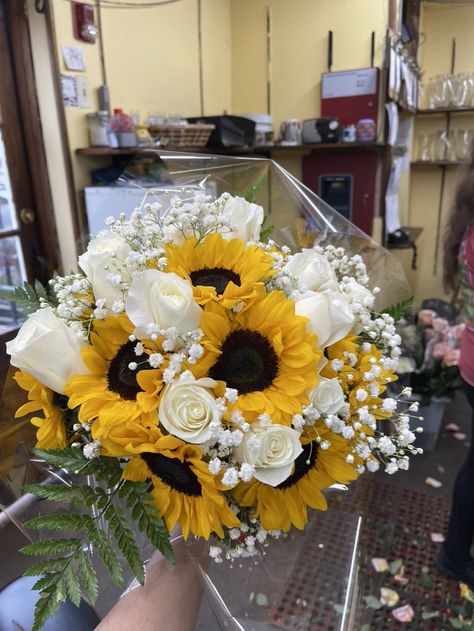 White roses and sunflowers in a wrapped bouquet White Roses And Sunflower Bouquet, White Roses With Sunflowers, Roses And Sunflowers, Sunflowers And White Roses, White Roses And Daisy Bouquet, Sunflower And White Rose Bouquet, Sunflower White Rose Bouquet, Sunflowers White Roses, Sunflower Pink Rose Bouquet