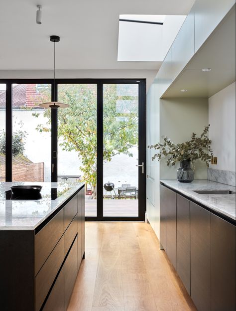 An open plan kitchen with large island and bifold doors Modern Metal Kitchen, Wrap Around Extension, Timeless Kitchens, Cozy Home Aesthetic, Contemporary Style Kitchen, Kitchens Modern, Extension Plans, Glass Extension, Kitchen Stool