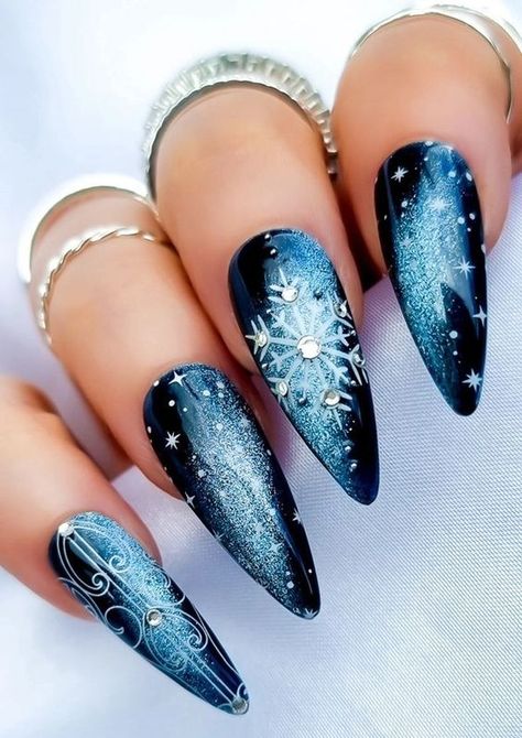 Discover 17 blue Christmas nails for 2024-2025, perfect for winter with stunning glitter, matte, and sparkle designs. These nails are ideal for almond, oval, square, and coffin shapes, offering a chic look with winter sparkle. Whether you prefer short acrylics or natural nails, these designs combine bling, light and dark blues, and elegant white accents to make your holiday season shine. Pretty Nails For Christmas, Frosty Winter Nails, Snowflakes Nail Art, Blue Black White Nails, Christmas Nails Extra, Winter Blue Nail Designs, Nail Winter Designs, Winter Nails Blue And White, Black Christmas Nails Winter