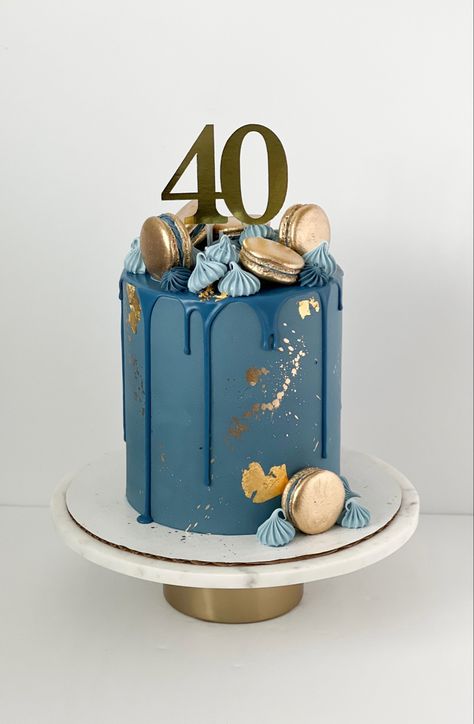 Navy blue cake with darker blue drip. Gold accents along side of cake. The top and side are decorated with gold macarons and blue meringues. In the middle there is a gold cake topper that reads “40”. Gold And Blue Cake Birthday Men, Chocolate Shavings On Cake, Blue 40th Birthday Cake, Male Cake Designs, Men’s Cake Design, Blue Macaron Cake, Birthday Cake 11 Boy, Male 40th Birthday Cake, 40th Birthday Ideas For Men Cake