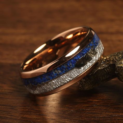 "\"Elevate your style with our Rose Gold Plated Tungsten Carbide Meteorite & Blue Lapis Lazuli Men's Band Ring, a celestial masterpiece of elegance and mystique. Meticulously crafted, this exceptional ring seamlessly marries the cosmic allure of meteorite with the captivating charm of blue lapis lazuli. The rose gold plating adds a touch of luxury, creating a harmonious contrast. Crafted for lasting comfort and resilience, this ring isn't just an accessory - it's a reflection of your unique journey and the bond you share. With its distinct materials and enduring quality, it's a true testament to your individuality and the extraordinary partnership you're embarking upon, a symbol of both earthly and celestial connections.\" Product Description: Superior Quality Tungsten Ring - Absolutely Wi Wedding Ring Rose Gold, Rose Gold Mens Ring, Modern Groom, Mens Band Rings, Mens Wedding Bands Tungsten, Meteorite Ring, Rings Mens Wedding Bands, Lapis Lazuli Ring, Blue Lapis Lazuli