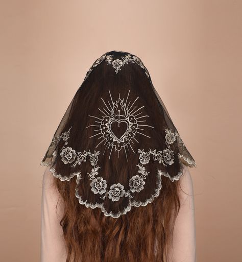 Follow us on ins, and give out coupons from time to time. https://www.instagram.com/mantveils/ Step into the realm of sacred symbolism with a mesmerizing triangular veil, bringing a touch of ethereal elegance and deep symbolism. This veil is handmade from lightweight lace material and measures approximately 39.4inches*19.7inches with a perfect triangular shape. The light, soft fabric is embroidered with delicate sacred heart and crosse. The edge of the veil is delicate and charming wavy lace and embroidered with small camellias. This veil is more than just an accessory, it's a sign of respect for your beliefs! It resonates with the spirit of the Catholic faith and is perfect for church Masses, devotional Catholic ceremonies and solemn ceremonies. This veil comes with two small 9-tooth clip Christian Head Covering Style, Face Covering Veil, Heart Veil, Nun Veil, Pagan Veiling, Catholic Veils, Lace Headscarf, Vintage Wedding Veil, Embroidery Veil