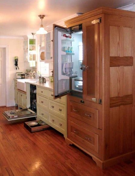 What appears to be a restored, vintage icebox is actually a three-sided cabinet of oak paneling built by the homeowner to conceal a modern refrigerator. The dishwasher, too, is hidden in cabinets. Photo by Bill Ticinito. Vintage Kitchen Art, Modern Refrigerator, Vintage Kitchen Appliances, Kitchen Appliance Storage, Outdoor Kitchen Appliances, Appliances Design, Victorian Kitchen, Arts And Crafts House, Oak Panels