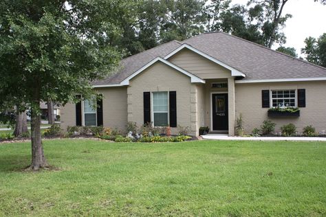 tan house with black door - Google Search Tan Painted Brick, Brick House With Shutters, Tan Brick House, Interior Front Door Trim, Brick House Ideas, House With Shutters, Outdoor House Colors, Painted Brick House Exterior, Shutters Interior