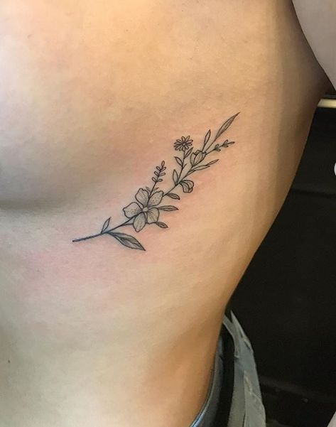 Hip Tattoos Women Outline, Marigold Rib Tattoo, Wild Flower Rib Tattoo, Tulip Rib Tattoo, Flower Tattoos Rib Cage, Wildflower Rib Tattoo, Flower Ribcage Tattoo, Under Rib Tattoo, Side Of Rib Tattoo Women