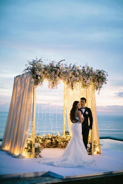 How unreal is Thailand for a destination wedding location?! We are sharing all the pastel beauty from this Phuket ceremony overlooking the ocean, with draped pinks, lush floral arrangements and string lights overflowing. Modern meets romance all the way down to the whimsical cake display with cascades of geometric shapes. Check out the full story on #ruffledblog Wedding Altar Decorations, Dream Beach Wedding, Phuket Wedding, Thailand Wedding, Wedding Altars, Wedding Stage Decorations, Outdoor Wedding Decorations, Wedding Forward, Wedding Stage