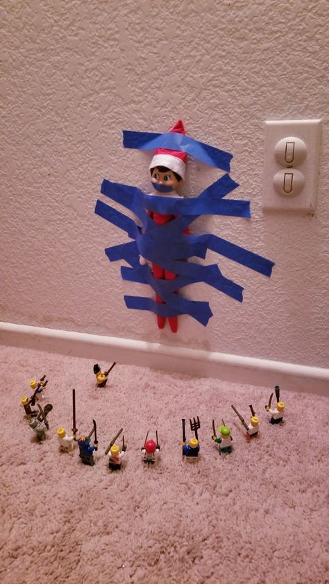 Elf has been taped to the wall by a horde of armed lego men Elf On The Shelf Ideas With Lego, Elf On The Shelf Taped To The Wall, Lego Elf On The Shelf, Elf On The Shelf With Legos, Elf Lego Ideas, Elf On The Shelf Lego Ideas, Elf 2024, Lego Men, Elf Reindeer