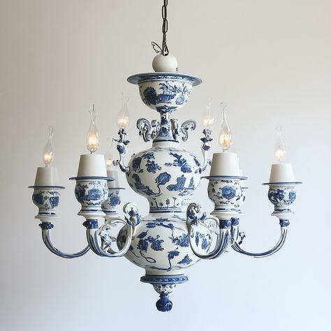 A delftware chandelier is a stunning fusion of artistry and craftsmanship, featuring intricately hand-painted ceramic elements inspired by the classic Dutch delftware style. The chandelier’s arms and central body are adorned with traditional blue and white motifs, often depicting floral patterns, pastoral scenes, or historical designs. Each ceramic piece is meticulously glazed to achieve a glossy finish, reflecting light beautifully while adding a touch of elegance to any room. The chandelier... Reflecting Light, Historical Design, Hand Painted Ceramics, Floral Patterns, Floral Pattern, Blue And White, Hand Painted, Ceramics, Floral