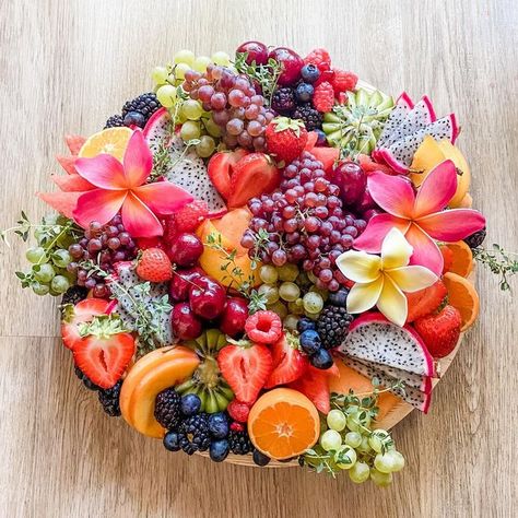 Stems - Cheese, Charcuterie & Catering on Instagram: "Pretty freakin obsessed with these plumerias from @metrogreens_ … if only we had them for last years Moana themed board with @weknowdisney … with that being said we get to have some fun this Tuesday LIVE creating another Disney inspired board! Any guesses on what inspired this board?" Fruit Platters Ideas, Fruit Only Charcuterie Board, Beach Theme Fruit Display, Fruit Chacuritie Board Ideas, Hawaiian Cheese Board, Beach Charcuterie Board Ideas, Tropical Fruit Board, Moana Charcuterie Board, Encanto Charcuterie Board