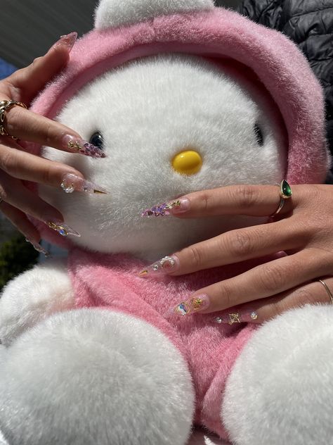 hello kitty vibes - sailor moon sparkly long almond nails - glitter and gold charms, transparent pink stiletto nails press on nail inspo summer nails 2023 outfit inspo kawaii core japanese style nails #sanrio #mymelody #kuromi #kawaiicore #sanriocore #summernails #pinkaesthetic #hellokitty #plushie #nailinspo Pink Pointy Nails, Outfit Inspo Kawaii, Japanese Style Nails, Sailor Moon Pink, Pink Sailor Moon, Nails Sanrio, Sailor Moon Style, Kawaii Sailor Moon, Pink Stiletto Nails