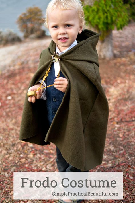 A Frodo costume for a toddler, including a glowing sword, a cloak, and the one ring | Halloween costume | Hobbit from The Lord of the Rings Hobbit Cloak Diy, Hobbit Cloak Pattern, Toddler Hobbit Costume, Lord Of The Rings Family Costumes, Baby Hobbit Costume, Diy Hobbit Costume, Captain America Toddler Costume, Frodo Costume, Hobbit Cloak