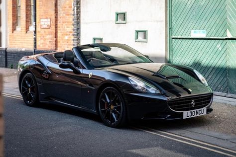 A sleek, all-black example of Ferrari’s stylish convertible grand tourer. Ferrari California Black, Black Convertible Car, Ferrari Convertible, Black Ferrari, Black Convertible, Dream Car Garage, Ferrari California, Pretty Cars, London United Kingdom