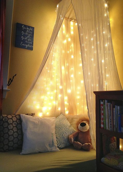 reggio reading space | DIY toddler reading nook -White christmas lights, old crib mattress ... Toddler Reading Nooks, Old Cribs, Canopy Bed Curtains, White Christmas Lights, Diy Canopy, Decor Ikea, Dekorasi Kamar Tidur, Bed Canopy, Christmas Bedroom