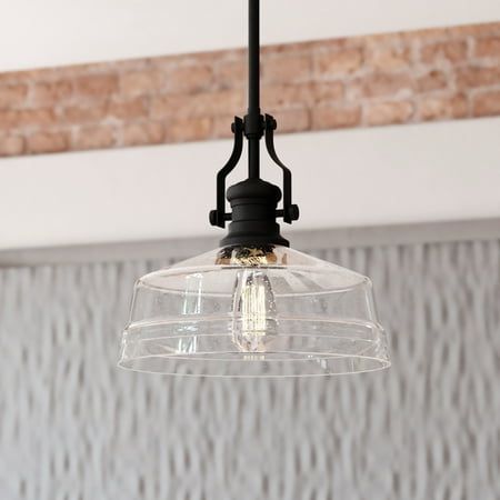 The Beloit pendant adds a welcoming and inviting feel to your kitchen or living spaces. Soft curving lines finished in matte black paired with a large clear seeded glass shade create a look that accents the most comfortable spaces. Combine that with a vintage Edison style filament bulb to complete the look. Bring a level of sophistication to your trendy farmhouse or urban style with this pendant. Size: 12-in. W x 17-in. H x 12-in. D. Light Over Sink, Kitchen Island Hanging Lights, Trendy Farmhouse, Farmhouse Kitchen Lighting, Sink Lights, Black Farmhouse, Large Pendant Lighting, Farmhouse Pendant Lighting, Dome Pendant Lighting