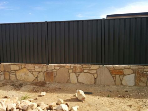 Colorbond fence on our sandstone retaining wall Sandstone Fence Front Yards, Sandstone Fence, Stonewall Fence, Sandstone Retaining Wall Landscaping, Retaining Wall Safety Fence, Garden Retaining Wall, Sandstone Wall, Paving Design, House Fence Design