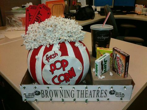 Made for work pumpkin contest. Painted pumpkin to look like old fashioned popcorn box. Strung popcorn on thread with needle. Glued round florist foam to top for heigth, then glued popcorn strands in "realistic mess". Attached 2 larger than normal "admit one" tickets with glue to foam. Used empty soda cup & empty candy boxes. Cut out holes in small box to keep candy/cup in place. Placed all in a box lid. Used battery operated lights & polked wholes thru box to mimic "marquee look". Creative Pumpkin Decorating Contest, Popcorn Pumpkin, Creative Pumpkin Decorating, Autumn Spirit, No Carve Pumpkin Decorating, Soda Cup, Pumpkin Decorating Contest, Pumpkin Decorating Ideas, Pumpkin Contest