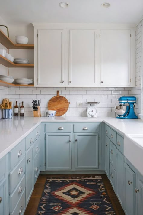 Light blue kitchen cabinets enhance a white-tiled kitchen with a modern, clean aesthetic. Light Blue Cabinet Paint Colors, Blue Cabinets White Countertops, Best Kitchen Cabinet Colors, Light Blue Cabinets, Unique Kitchen Ideas, Colored Kitchen Cabinets, Blue Kitchen Cabinet, Colored Cabinets, Yellow Kitchen Cabinets