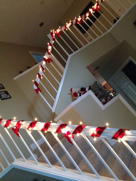 Candy cane banister Candy Cane Fireplace Decor, Candy Cane Themed Christmas Decor, Candy Cane Staircase, Candy Cane House Decorations, Candy Cane Hallway Decorations, Christmas Railing Ideas, Christmas Decor Stairs Railings, Diy Candy Cane Decorations, Banister Christmas Decor