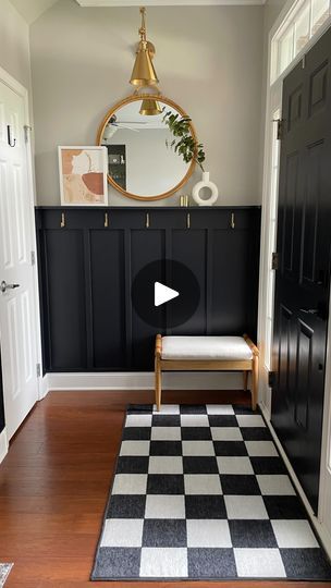 60K views · 8.1K reactions | The entryway reveal you’ve all been waiting! In case you missed it, let me catch you up: We added custom board and batten to define this entry way, painted it in “very black” by valspar, added gold wall hooks, a wall mirror, and a gold wall sconce. @breanneockeyhiser made some DIY custom wall art that I helped her build a frame for and we added that to the shelf we included in the board and batten build. We added a small bench for functionality and the cutest washable checkered rug to hide the outdated floor tile!  Let us know what you think in the comments and don’t forget to hit that follow button for more DIY’s like this!  #boardandbatten #custombuild #customhome #diyproject #diyprojects #interiordesign #diyhacks #diyidea #entryway #entrywaylighting #entrywa Board And Batten Entry Wall With Hooks, Front Entryway Board And Batten, Dark Board And Batten Entryway, Black And White Board And Batten, Foyer Board And Batten Entryway, Tiny Entryway, Shaker Wall, Build A Frame, Board And Batten Wall