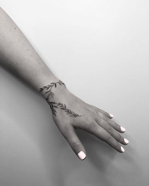 Long Wrist Tattoos For Women, Leaf Vine Hand Tattoo, Wrist Wrapping Tattoos, Black And White Hand Tattoos, Wrist Plant Tattoo, Fern Wrist Tattoo, Leaf Tattoo Hand, Wrist Leaf Tattoo, Fineline Wrist Tattoo