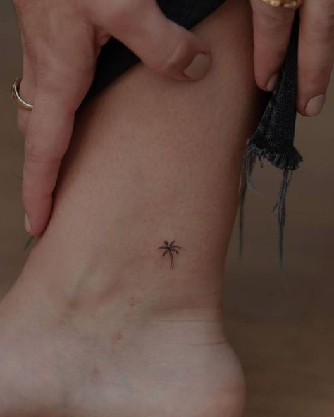 White Palm Tree Tattoo, Palm Tree On Ankle, Ankle Tattoo Palm Tree, Ankle Tree Tattoos For Women, Tiny Island Tattoo, Tiny Palm Tree Tattoos For Women, Dainty Vacation Tattoos, Small Holiday Tattoos Simple, Small Palm Tree Tattoo Ankle