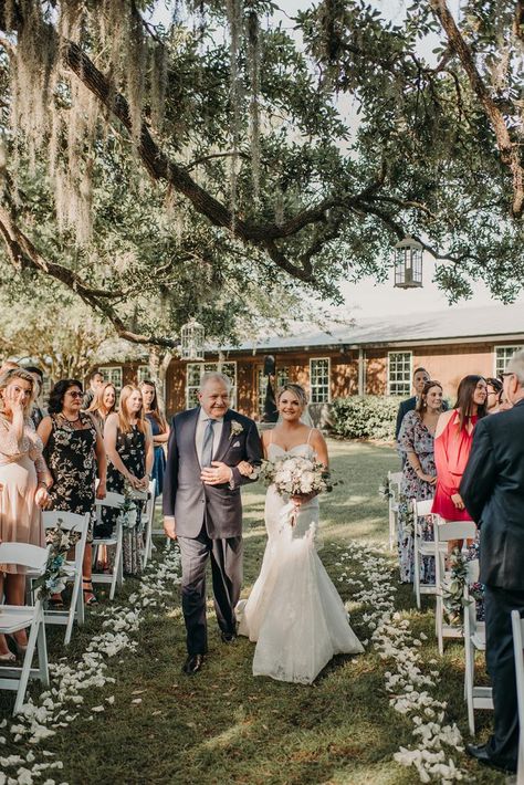 Linea and her father walking down the aisle White Flowers On Cross Wedding, Green And White Aisle Flowers, Floral Cross Wedding Ceremony, Cowbell Creek Wedding, Brush Creek Ranch Wedding, Wedding Organiser, Modern Wedding Centerpieces, Wedding Photography List, Wedding Shot List