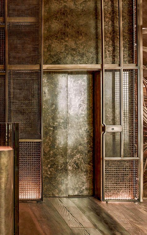 An atmospheric lift area and elevator cladding was created using bronze and copper tones. Lift Cladding, Elevator Lobby Design, Piccadilly London, Lift Lobby, Elevator Interior, Stainless Steel Texture, Restaurant London, Elevator Lobby, Stair Lift