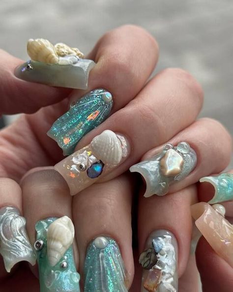 Explore the depths of the ocean with these captivating coffin nails inspired by the sea. With a serene color scheme of aquamarine and delicate pearl white, each nail is meticulously embellished with miniature seashells and starfish, complemented by shimmering pearls that glimmer in the light. The combination of glossy and matte textures creates a striking juxtaposition, evoking the dynamic nature of the ocean's surface. Nautical Nail Designs, Nautical Nails, Sea Nails, Summer Nail Designs, Iridescent Pearl, Nail Art Pen, Dotting Tool, Aura Colors, Sea Inspired