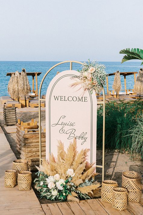 “Whimsical Folk” Wedding Style. Coastal ceremony at Tulum. Reception at Kalami Beach Bar Restaurant. Mediterranean Sea Views. Colors: White, Beige, Terracotta, Dusty Pink, Green. Destination Wedding Planned by Golden Apple Weddings, Rhodes Island. Bride and Groom Wedding Portraits. #destinationweddings #Greece #Rhodes #island #bohowedding #beachwedding #beachbar #weddingtheme #weddingdecor #weddingevent #weddingphotography #weddingplanning #welcomesign #rattanlanterns #flowersynthesis #pampas Mediterranean Beach Wedding, Wedding Welcome Sign Beach, Beach Wedding Welcome Sign, Pampas And Roses, Coastal Ceremony, Coastal Wedding Reception, Beach Bar Restaurant, Beach Wedding Aisles, Flower Floor