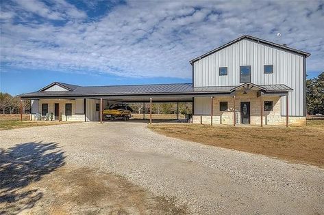 R2G Barndominiums on Instagram: "2021 barndo build with guest apartment on 5 acres in Gainesville, Texas. The home features high ceilings with exposed beams, quartz countertops, stone fireplace, secondary bedroom, 1.5 bathrooms on main floor, primary bedroom/bathroom upstairs. 4-car carport and 1 bedroom, 1 bathroom guest apartment. Outside is 1,400+ sq ft covered back patio and fully stocked pond. 3 BA 2.5 BA 2,508 Living SF +1 BD 1 BA Guest Quarters +Attached 4-Car Carport Built: 2021 Lot: Barndominium With Carport, Apartment Outside, Carport Addition, Countertops Stone, Carport Covers, Bathroom Upstairs, Guest Quarters, Covered Back Patio, Wood Building