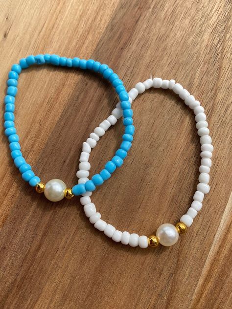 Comes in blue or white please message once you order with the color you want  Clay bead bracelet Approximately 6.5 inches long  Elastic band.  My shop has other designs as well!! Please visit my Instagram  emr_smileybeads Please message me if you have any questions or need a bigger quantity!  thank you for supporting my small business! Small Beads Bracelets Ideas Aesthetic, Clay Bead Bracelet Aesthetic, Bracelet Ideas For Small Business, Clay Bead Bracelet Ideas With Pearls, Bracelet Ideas Small Beads, Bracelet Color Combos Beads, Sea Bead Bracelets Ideas, Breclate Design, Sea Bead Bracelets