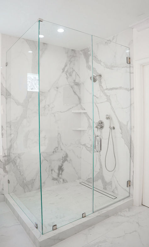 Image is a floor-to-ceiling shower with large-format porcelain in a white marble-like design. White Marble Shower, Marble Shower Walls, Marble Shower Tile, Shower Modern, White Marble Bathrooms, Full Bathroom Remodel, Bathroom Shower Walls, Marble Showers, Bathroom Inspiration Modern