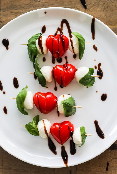 Make these adorable and delicious Heart Shaped Valentine's Caprese Skewers for Valentine's Day! Sliced grape tomatoes shaped into hearts are the star of this easy appetizer. Cherry Tomato Hearts, Valentines Caprese Skewers, Valentines Tomato Mozzarella, Tomato Hearts Shape, Heart Shape Food, Tomato Hearts, Tomato Mozzarella Skewers, Tomato Skewers, Valentines Party Food