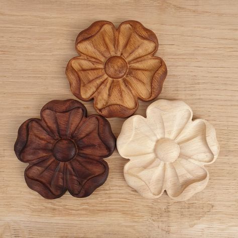 Carved Flower Rosette Rosette onlay decor ideal for fireplace, cabinet, cupboard decoration or anywhere that suits you. These ones have been wax stained with a Dark Mahogany, Tudor Oak or can be left natural for you to finish in the style you want. These are not cheap Pine, Resin or MDF as sold by others. They are carved from Hevea hardwood. Different sizes available from pop down menu. If you need a different size made just message me and i will sort you out Thank you for looking and be sure to Wood Carved Flowers, Carved Flowers, Rose Carving Wood, Wood Carving Flowers, Flower Carving Patterns, Art Sculpture En Bois, Carved Rosettes, Fireplace Art, Wooden Main Door Design