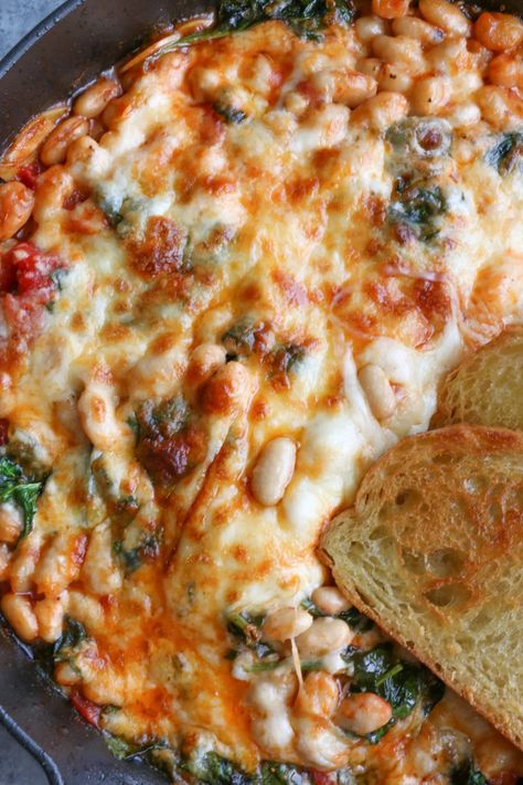 Cheesy White Bean Tomato Bake • Hip Foodie Mom Cheesy Italian Baked Cannelini Beans, White Beans Tomatoes, Vegetarian Olive Recipes, Baking With Beans, Main Dishes With Beans, Hearty Bean Recipes, Vegetarian Bean Casserole, Vegetarian Bake Recipes, Baked White Beans