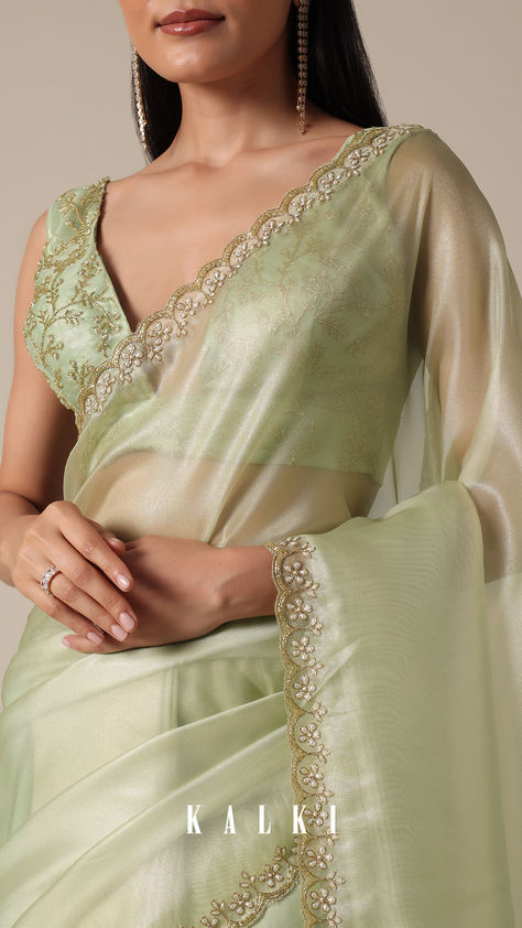 "Step into sophistication with this Graceful Green Tissue Saree. It is featuring meticulous bead and cutdana work on a scalloped border. The light green and glass tissue accents enhance the overall appeal, creating a perfect choice for your party wear collection. Meticulous detailing and the inclusion of unstitched blouse fabric ensure a customized fit.
" Glass Tissue Dresses, Saree Designs Party Wear Wedding, Blouse Design For Fancy Saree, Pelli Choopulu, Gold Tissue Saree, Light Green Saree, Cutdana Work, Kora Silk Sarees, Simple Saree Designs